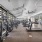 Wellness center with cardio equipment and garage doors for indoor-outdoor fitness
